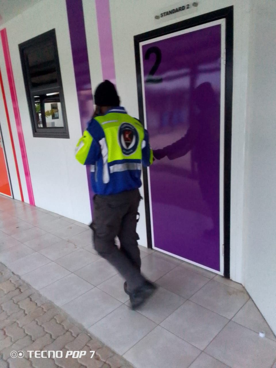 Kedith officer checking a classroom door on night patrol