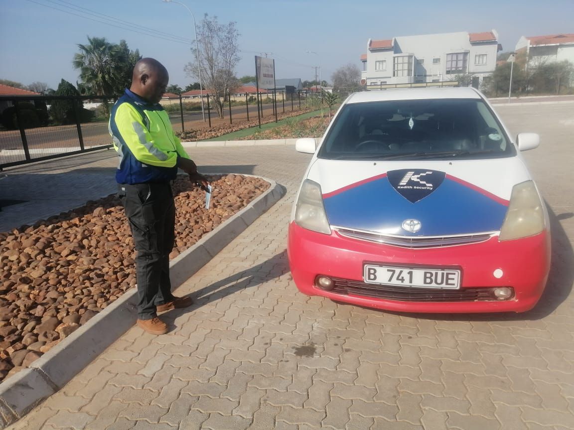 A Kedith supervisor checking a vehicle at the school entrance